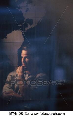 Businessman thinking standing near a world map View Large Photo Image Stock Image - Businessman thinking standing near a world map. Fotosearch