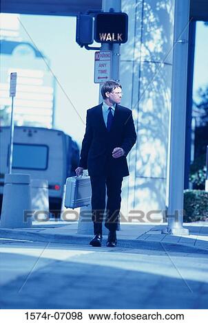 Stock Photo - Businessman walking on a street. Fotosearch
