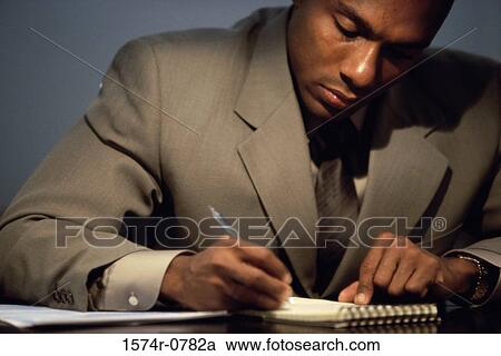 Businessman writing in a notebook View Large Photo Image Stock Image - Businessman writing in a notebook. Fotosearch