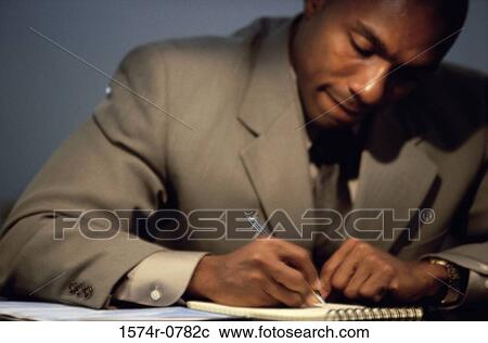 Businessman writing in a notebook View Large Photo Image Stock Image - Businessman writing in a notebook. Fotosearch