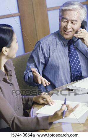 Businesswoman and a businessman in an office View Large Photo Image Stock Image - Businesswoman and a businessman in an office. Fotosearch