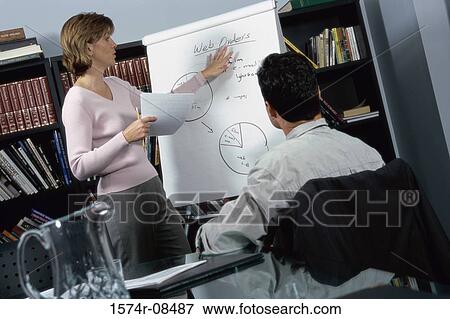 Businesswoman and a businessman discussing in an office View Large Photo Image Stock Photo - Businesswoman and a businessman discussing in an office. Fotosearch
