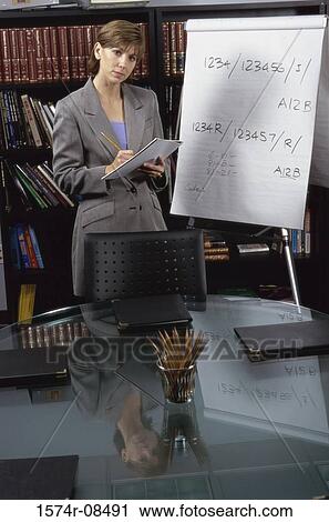 Businesswoman giving a presentation in an office View Large Photo Image Stock Image - Businesswoman giving a presentation in an office. Fotosearch