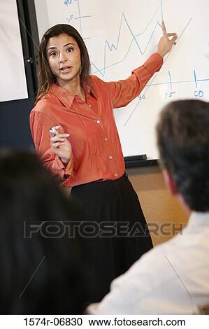 Stock Image - Businesswoman giving a presentation. Fotosearch