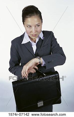 Businesswoman holding a briefcase View Large Photo Image Stock Image - Businesswoman holding a briefcase. Fotosearch