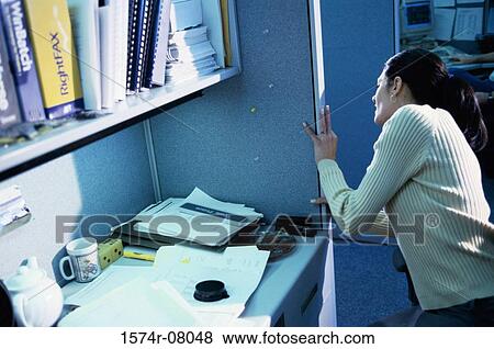 Businesswoman peeking from a doorway View Large Photo Image Stock Photo - Businesswoman peeking from a doorway. Fotosearch
