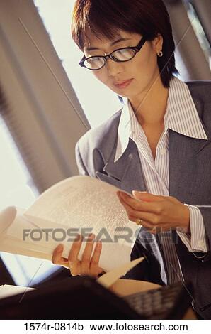 Businesswoman reading documents View Large Photo Image Stock Image - Businesswoman reading documents. Fotosearch