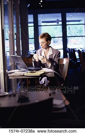 Businesswoman sitting in a restaurant View Large Photo Image Stock Image - Businesswoman sitting in a restaurant. Fotosearch