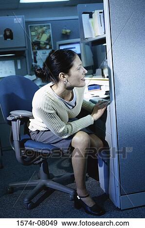 Businesswoman sitting in an office View Large Photo Image Stock Photo - Businesswoman sitting in an office. Fotosearch