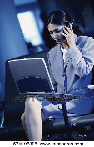 Businesswoman sitting talking on a mobile phone View Large Photo Image Stock Photo - Businesswoman sitting talking on a mobile phone. Fotosearch