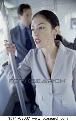 Businesswoman standing in a subway train View Large Photo Image Stock Photo - Businesswoman standing in a subway train. Fotosearch