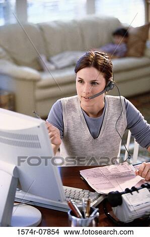 Picture - Businesswoman talking on a headset. Fotosearch