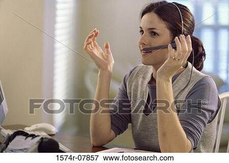 Stock Photo - Businesswoman talking on a headset. Fotosearch