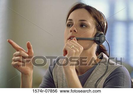 Stock Photograph - Businesswoman talking on a headset. Fotosearch