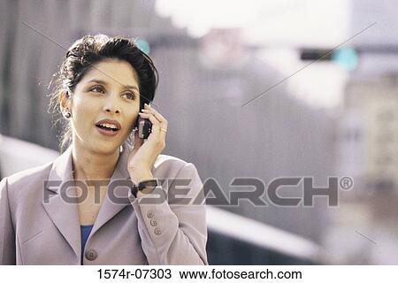 Businesswoman talking on a mobile phone smiling View Large Photo Image Stock Image - Businesswoman talking on a mobile phone smiling. Fotosearch