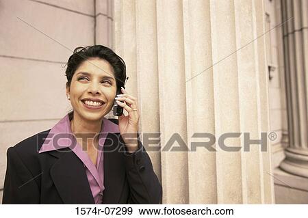 Stock Photo - Businesswoman talking on a mobile phone smiling. Fotosearch
