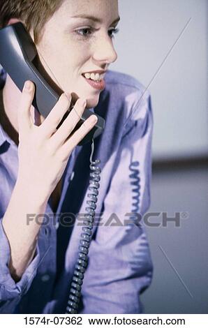Stock Image - Businesswoman talking on a telephone. Fotosearch