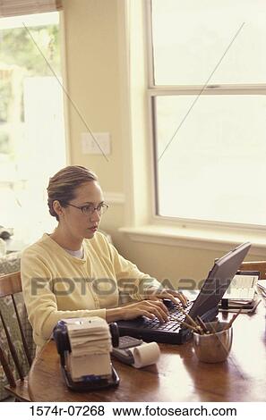 Stock Photo - Businesswoman using a laptop. Fotosearch