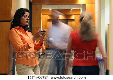 Picture - Businesswoman using a mobile phone. Fotosearch