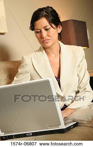 Businesswoman working on a laptop View Large Photo Image Stock Photo - Businesswoman working on a laptop. Fotosearch