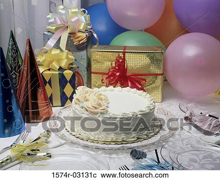 Stock Image - Close-up of a birthday cake and presents. Fotosearch