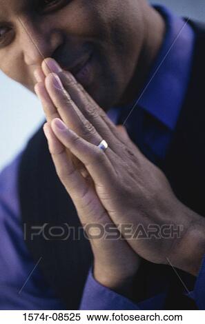 Close-up of a businessman praying View Large Photo Image Stock Photography - Close-up of a businessman praying. Fotosearch