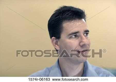 Close-up of a businessman smiling in an office View Large Photo Image Stock Image - Close-up of a businessman smiling in an office. Fotosearch