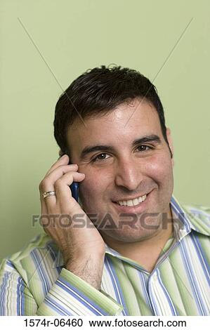 Close-up of a businessman talking on a mobile phone in an office View Large Photo Image Stock Image - Close-up of a businessman talking on a mobile phone in an office. Fotosearch
