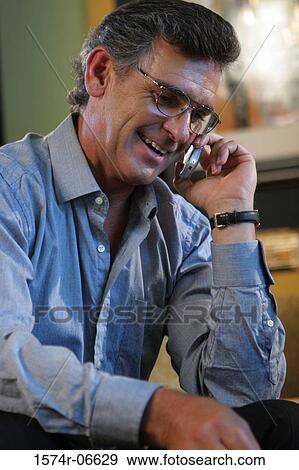 Close-up of a businessman talking on a mobile phone View Large Photo Image Stock Photo - Close-up of a businessman talking on a mobile phone. Fotosearch