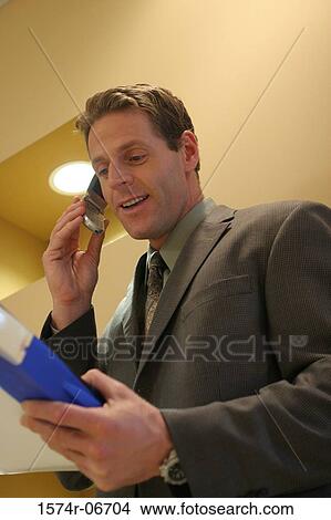 Close-up of a businessman using a mobile phone View Large Photo Image Picture - Close-up of a businessman using a mobile phone. Fotosearch