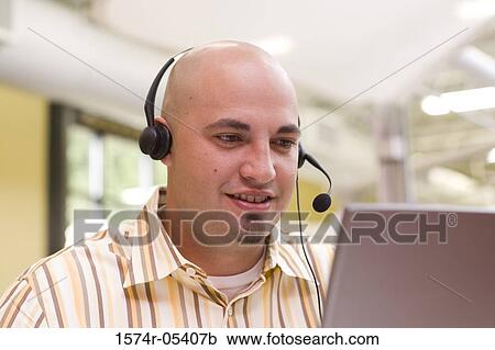 Close-up of a businessman wearing a headset in an office View Large Photo Image Stock Image - Close-up of a businessman wearing a headset in an office. Fotosearch