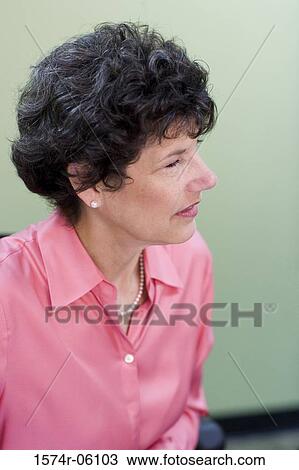 Close-up of a businesswoman sitting in an office View Large Photo Image Stock Image - Close-up of a businesswoman sitting in an office. Fotosearch