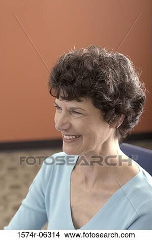 Close-up of a businesswoman smiling in an office View Large Photo Image Picture - Close-up of a businesswoman smiling in an office. Fotosearch