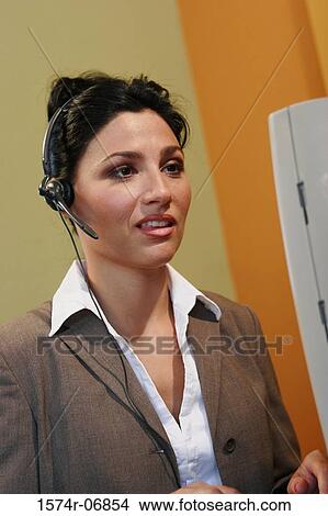 Picture - Close-up of a businesswoman wearing a headset. Fotosearch