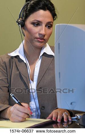 Stock Photo - Close-up of a businesswoman working in an office. Fotosearch