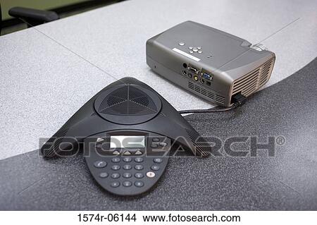 Close-up of a conference phone and projection equipment in an office View Large Photo Image Picture - Close-up of a conference phone and projection equipment in an office. Fotosearch