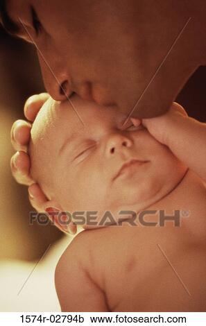 Stock Image - Close-up of a father carrying his baby boy. Fotosearch