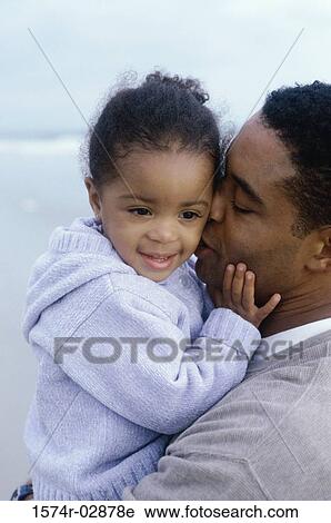 Close-up of a father kissing his daughter View Large Photo Image Stock Image - Close-up of a father kissing his daughter. Fotosearch
