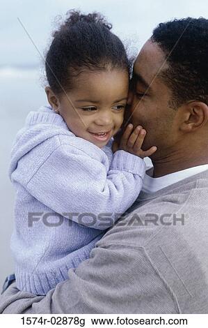 Close-up of a father kissing his daughter View Large Photo Image Stock Image - Close-up of a father kissing his daughter. Fotosearch