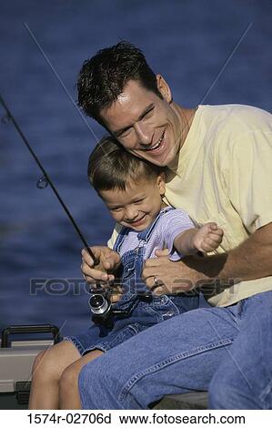 Close-up of a father teaching his son fishing View Large Photo Image Stock Image - Close-up of a father teaching his son fishing. Fotosearch