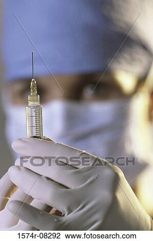 Close-up of a female doctor holding a syringe View Large Photo Image Stock Image - Close-up of a female doctor holding a syringe. Fotosearch
