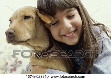 Close-up of a girl holding her dog View Large Photo Image Stock Image - Close-up of a girl holding her dog. Fotosearch