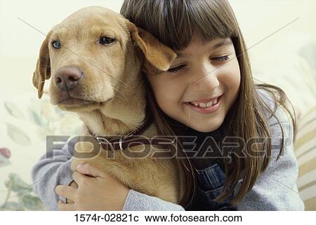 Close-up of a girl holding her dog View Large Photo Image Stock Image - Close-up of a girl holding her dog. Fotosearch