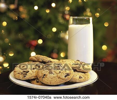 Close-up of a glass of milk and a plate of cookies View Large Photo Image Stock Image - Close-up of a glass of milk and a plate of cookies. Fotosearch