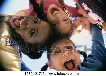 Close-up of a group of children in a huddle View Large Photo Image Stock Image - Close-up of a group of children in a huddle. Fotosearch