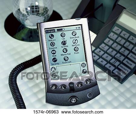 Close-up of a hand held device near a telephone and a globe View Large Photo Image Stock Image - Close-up of a hand held device near a telephone and a globe. Fotosearch