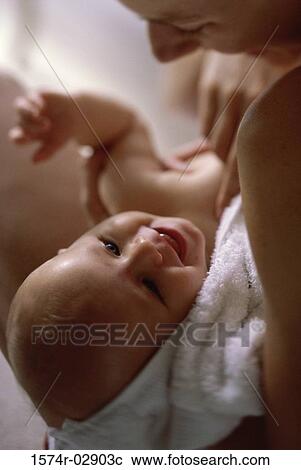 Stock Image - Close-up of a mother holding her baby boy. Fotosearch