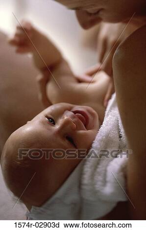 Stock Image - Close-up of a mother holding her baby boy. Fotosearch
