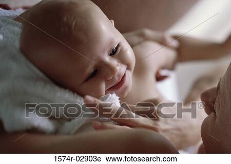 Stock Image - Close-up of a mother holding her baby boy. Fotosearch