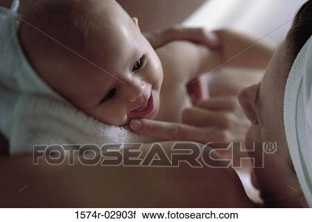 Close-up of a mother holding her baby boy View Large Photo Image Stock Image - Close-up of a mother holding her baby boy. Fotosearch